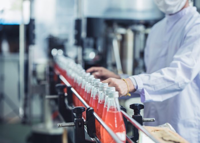 Drink factory - closeup hygiene worker working check juice glass bottled in production line
