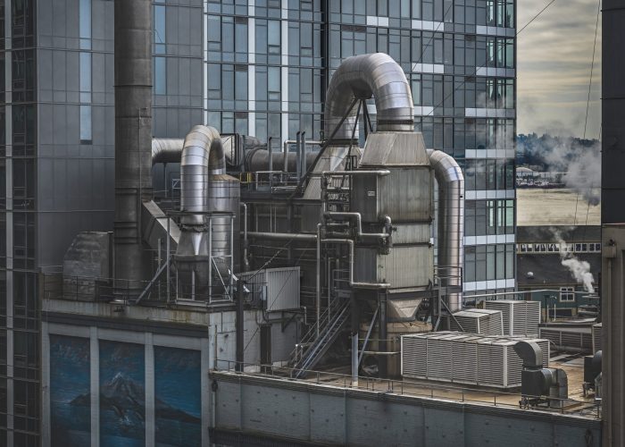 A factory surrounded by high-rise buildings with greenery on the background in Seattle