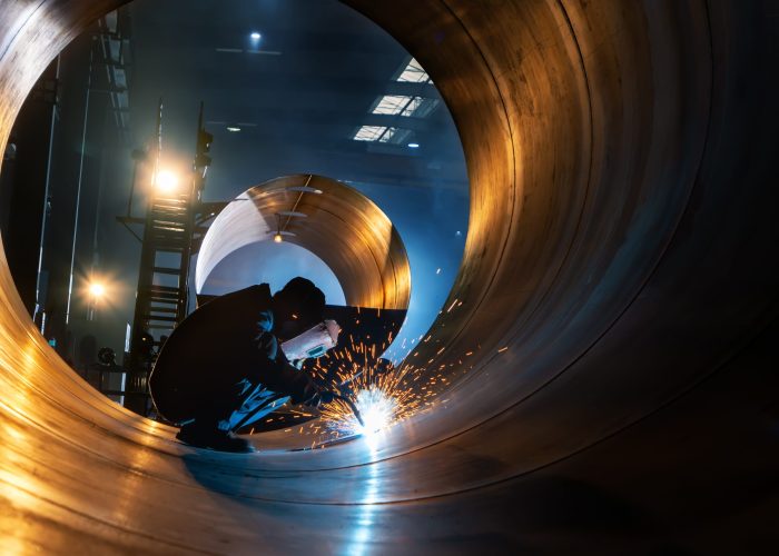 The welder is welding steel plates