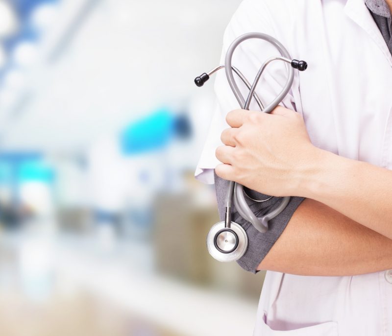 doctor-with-stethoscope-hands-hospital-background